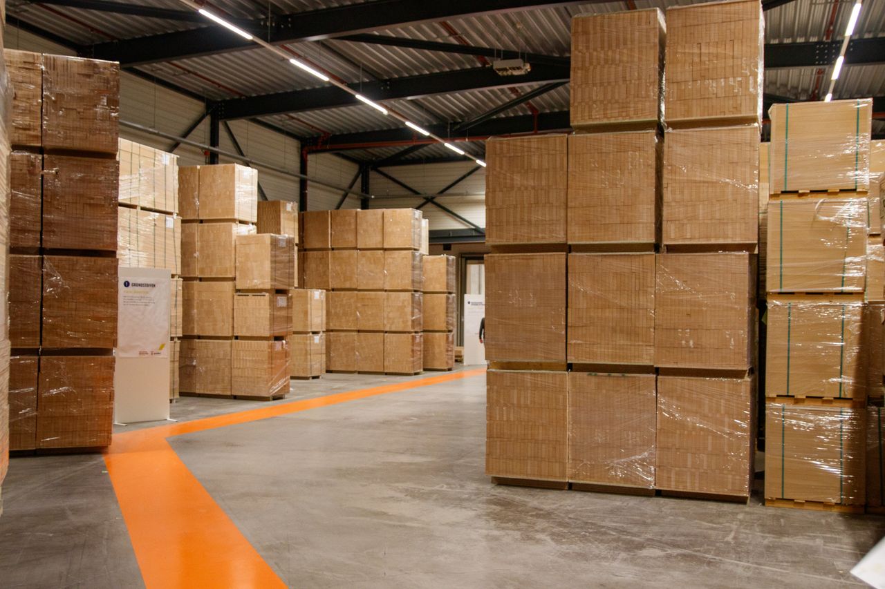 Mastering the First Impression: Your intriguing post title goes here A spacious industrial warehouse filled with stacked cardboard boxes for storage and shipping.